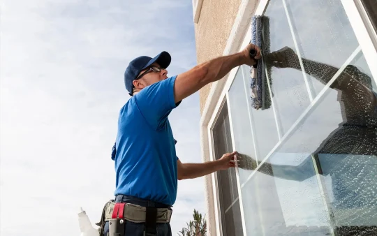 Professional window cleaner at work